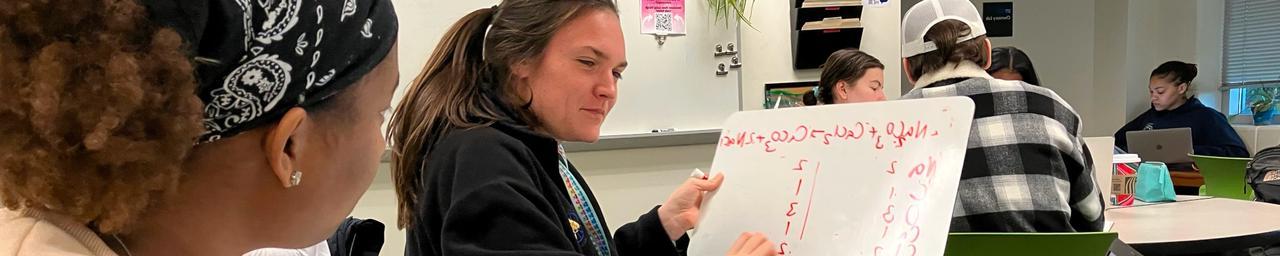 Student tutor at the Chemistry Success Center holds a whiteboard